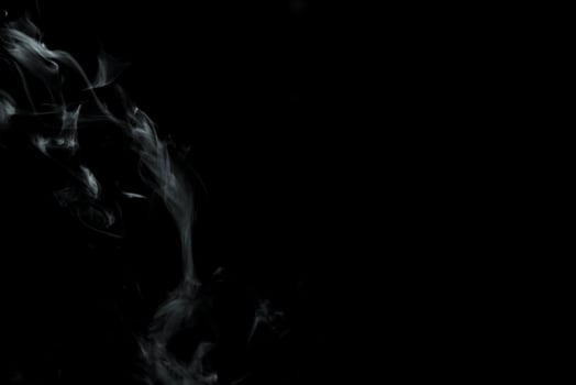 Abstract powder or smoke isolated on black background photo