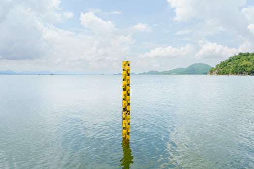 The yellow scale measures the height of the water in the dam. The water in the reservoir is plentiful and is used for agriculture and the village consumption.Reserving water nature in Thailand photo