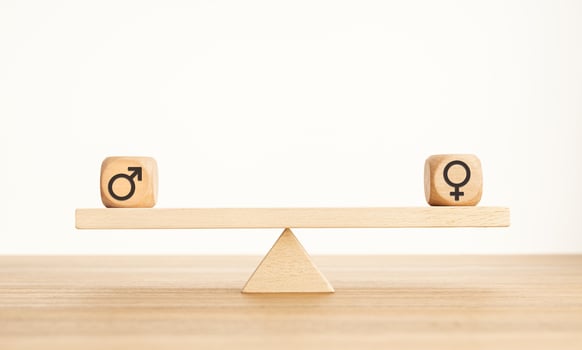 Gender equality concept. Wooden block with gender icon on a seesaw. Copy space photo