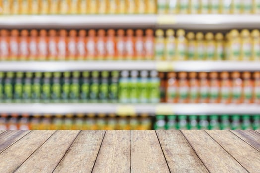 wood table top in Supermarket aisle with beverage product shelves photo