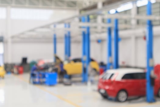 car service centre with auto at repair station bokeh light defocused blur background photo