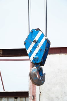 Crane boom with isolated hook, blue sky background photo