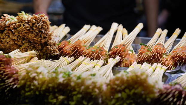 The delicious chinese food cooking with the strings of mutton on the sticks photo
