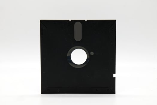 Vintage Floppy Disk 5.25 inch. Retro storage technology on white background. photo