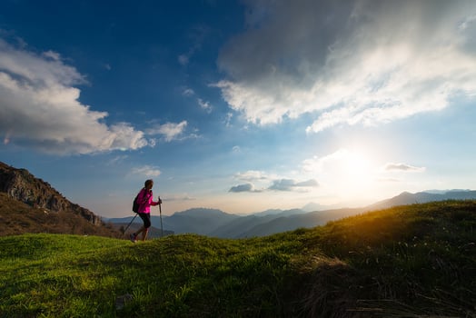 Trekking at sunset in the mountains alone photo