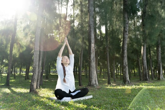 Girl do yoga pose at the park in the morning with sunlight. photo