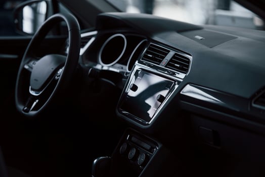 Front part of brand new automobile. Modern black interior. Conception of vehicles photo