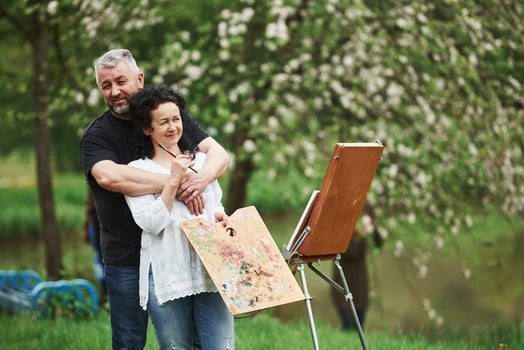 Feeling good. Mature couple have leisure days and working on the paint together in the park photo
