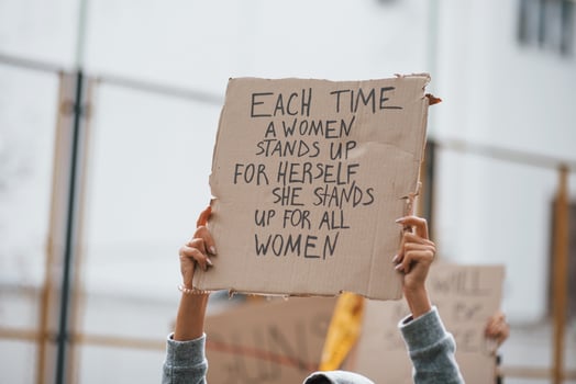 Demonstration is on action. Group of feminist women have protest for their rights outdoors photo