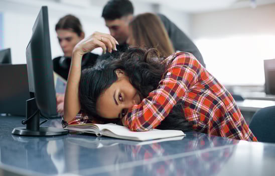 Tired a little. Group of young people in casual clothes working in the modern office photo