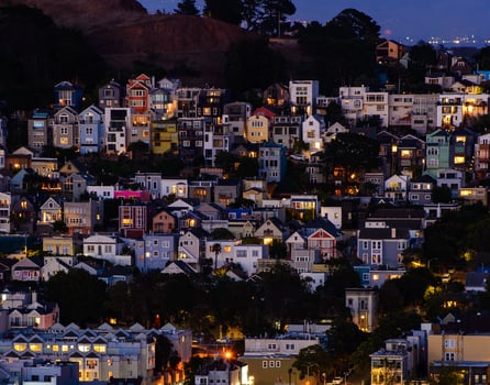 Golden hour neighborhood hill view of San Francisco homes, peaked roofs - colorful and scenic with some Victorian homes - a typical San Francisco view. photo