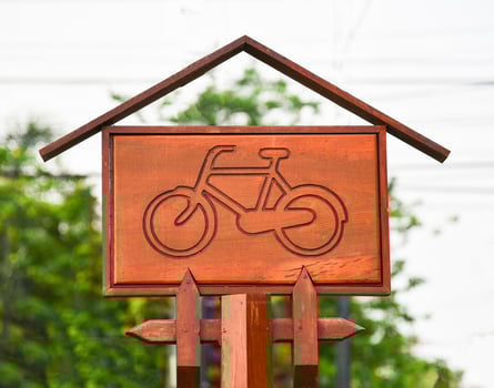 bicycle lane sign Wooden sign bike on the road in public park photo