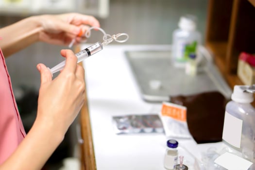 A picture of nurse hands in preparation an injection vaccine for the patient. photo