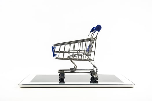 shopping cart with tablet on white backgrond , Means shopping online photo