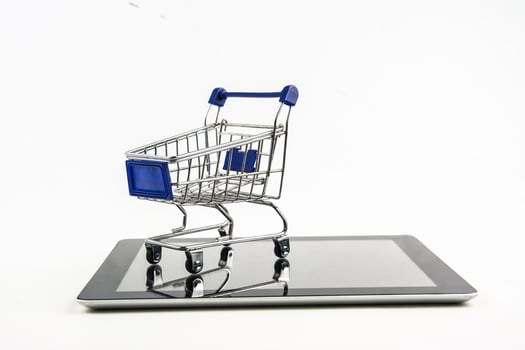 shopping cart with tablet on white backgrond , Means shopping online photo