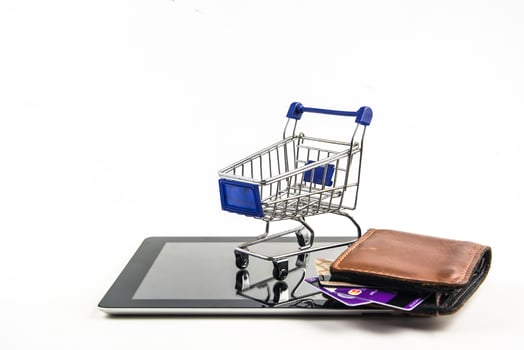 shopping cart with tablet on white backgrond , Means shopping online photo