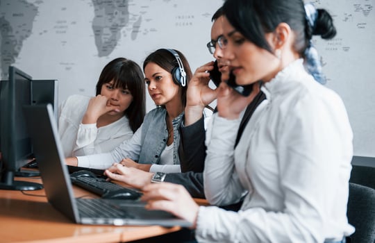 Helping the employee. Young people working in the call center. New deals is coming photo
