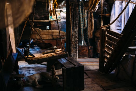 Wooden winch of a sailing ship and ropes on the deck of medieval pirate warship photo