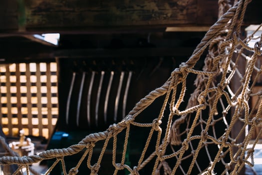Wooden winch of a sailing ship and ropes on the deck of medieval pirate warship photo