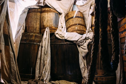 Wooden winch of a sailing ship and ropes on the deck of medieval pirate warship photo