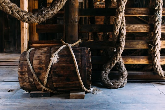 Wooden winch of a sailing ship and ropes on the deck of medieval pirate warship photo