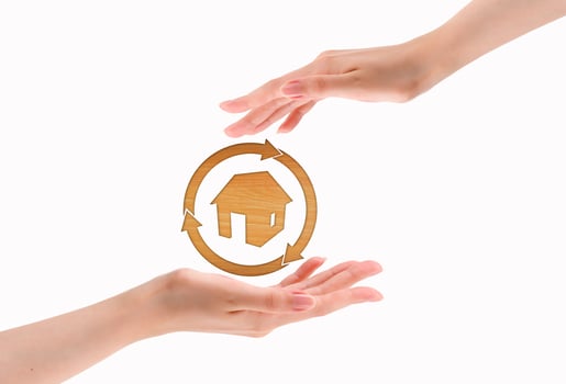 Hands make heart shape with wood house photo