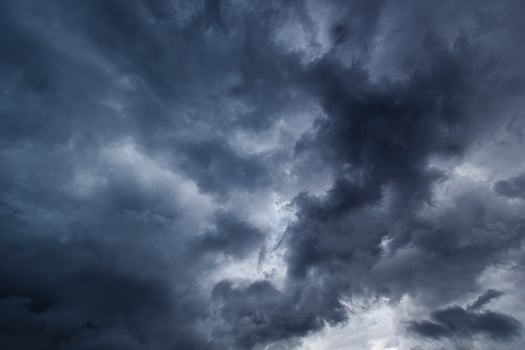 The dark sky with heavy clouds converging and a violent storm before the rain. photo