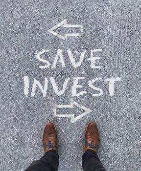 Top view on the words Save and Invest with arrows pointing left and right photo