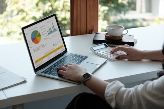 Businesswoman using calculator and laptop for calaulating finance, tax, accounting, statistics and analytic research concept photo