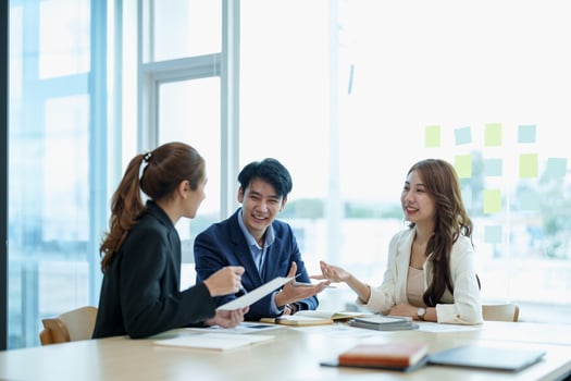 Happy group of business asian work cooperate with diverse team at office briefing, focused biracial businessman head meeting, collaborate discuss business ideas with colleagues at meeting photo