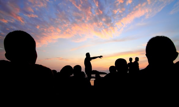 silhouette meeting team. sunset water photo