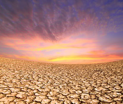 sunset on the ground dried by dryness photo