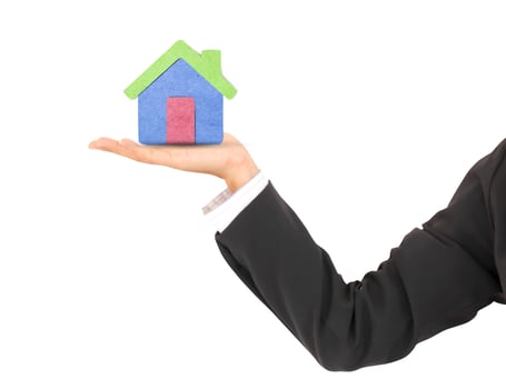 human hand   a house   with recycled paper stick photo