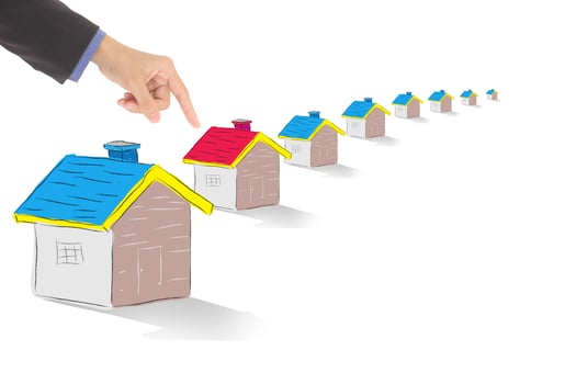 finger pointing red house, real estate concept photo