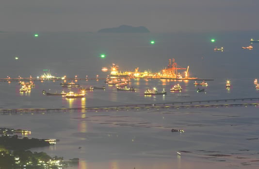 Port warehouse with cargoes and containers at night photo