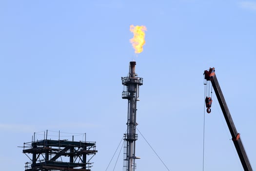the refinery flare with cloud in background photo