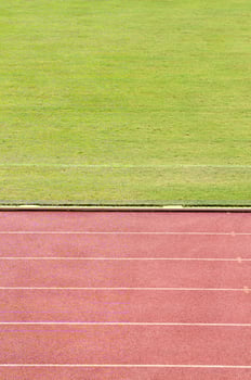 Running track with grass field photo