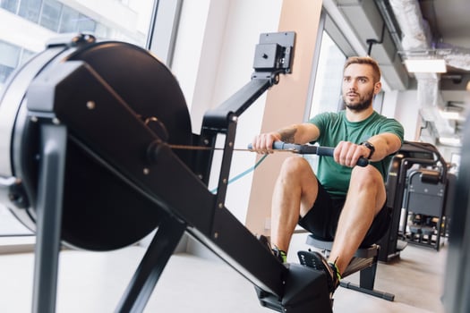 Active athlete man doing rowing workout photo