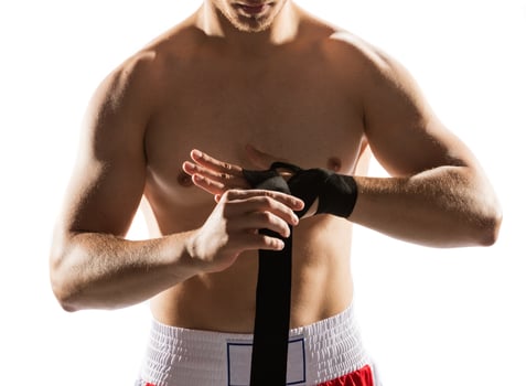 Boxer wrapping his hands with bandage photo