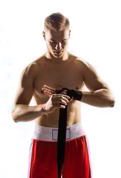Fighter wrapping his hands with elastic band. photo