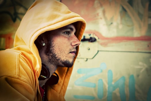 Young man portrait on graffiti grunge wall photo