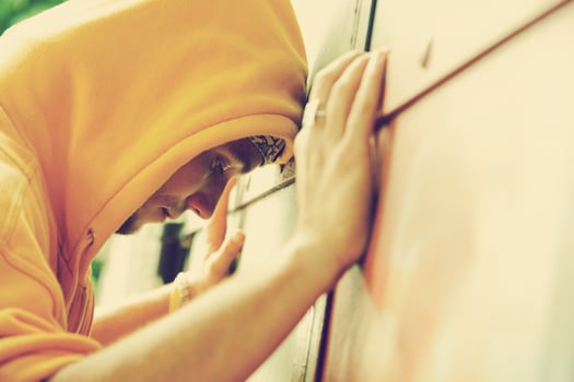 Young man on graffiti grunge wall photo