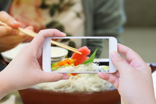 Taking photo of Japanese sashimi sushi set