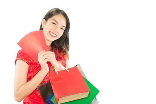 Happy Asian lady shopping in Chinese suite isolated over white copy space - woman day concept photo