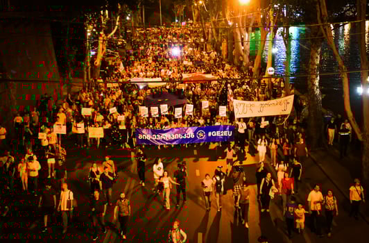Tbilisi, Georgia , 2022 - Aerial view people march in streets on major EU-pro rally event. Thousands of people on peaceful demonstration event. Pro-Europe rally event in capital city Georgia photo