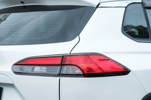 Back view part of white car with light photo