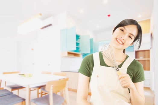 Happy lady holding kichen stuff over copy space background - people home made food preparation concept photo