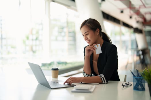 Close up of black girl hold bank credit card and type on laptop, shopping online using computer, buying goods or ordering online, entering bank accounts and details in online banking offer photo