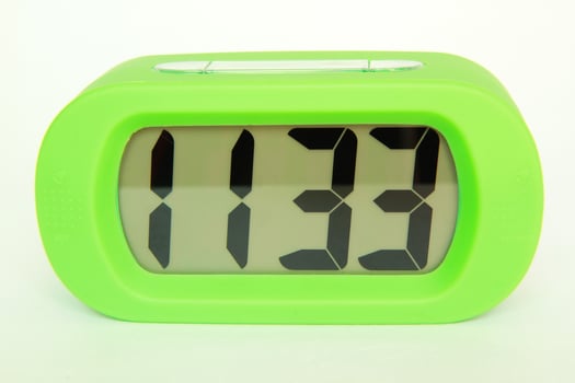 Green clock isolated on white background photo