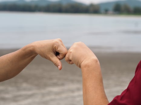 Two woman Alternative handshakes fist clenched hand greeting in the situation of an epidemic covid 19, coronavirus new normal social distancing photo